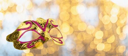 Golden carnival mask on bokeh backgroundの写真素材