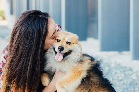 woman kissing dog with copy space for textの写真素材