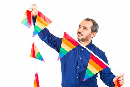 man placing garlands with the sign of gay prideの写真素材