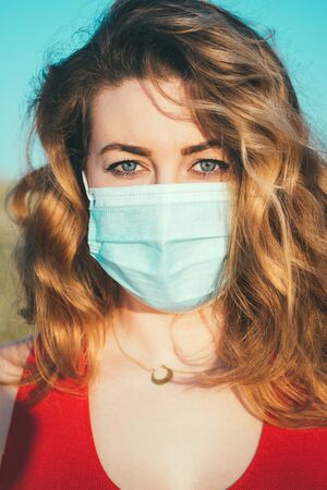 close-up portrait of a woman in a medical maskの写真素材