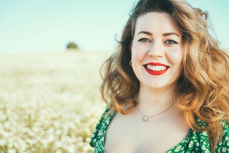 blonde woman with blue eyes enjoying freedom in the country