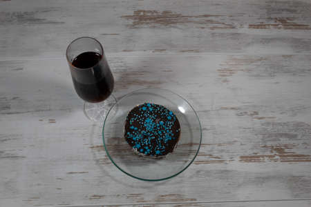 Close-up. View from above. On the table is a glass of wine, next to a cake on a saucer.の写真素材