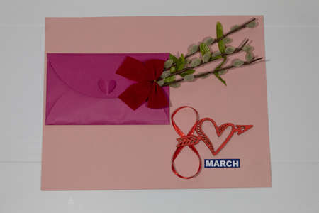 On a pink background is a pink envelope with willow branches and a red bow. At the bottom of the...