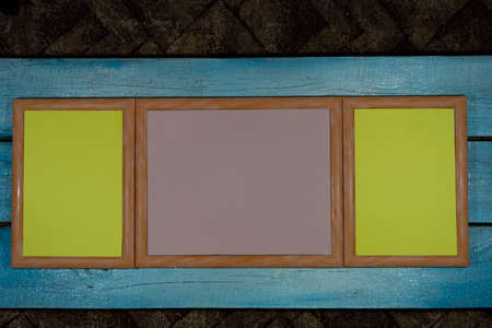 On a blue background, three identical frames are different in size with a yellow and pink middle.