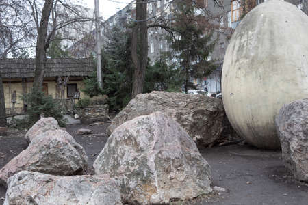 Close-up. Near the street city cafe are large stones.