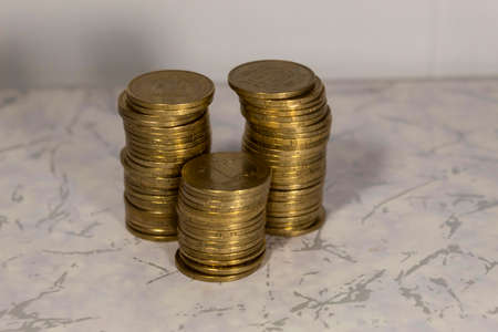 Metal coins are laid out in three piles.
