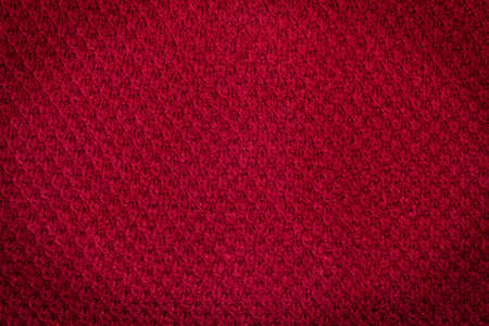 Background. Texture. Woolen knitted red fabric with darkened corners.の写真素材