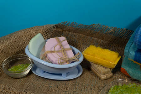 On jute fabric are things for spa treatments - sea salt, soap and brushes.