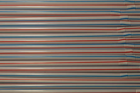 Background. Texture. On the table are laid out multi-colored tubules for drinks.