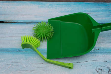 A scoop lies on the board, next to it is a brush sweeping away the coronavirus model - a symbol of victory over the disease.の写真素材