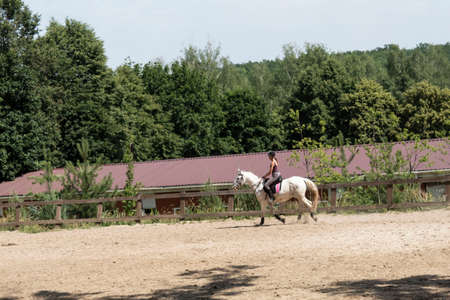 Kharkov, Ukraine. July, 4, 2020. After weakening the quarantine during coronavirus, the girl turns to her favorite sport - horseback riding.のeditorial素材