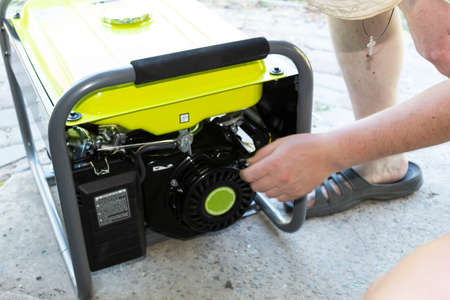On the porch is an additional source of energy gasoline generator. A man launches a generator.