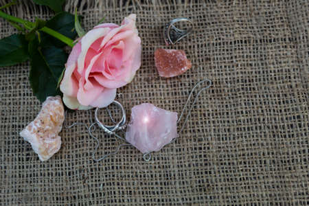 On the jute fabric are semi-precious stones pink quartz, dolomite, halite and pink rose. Nearby are...
