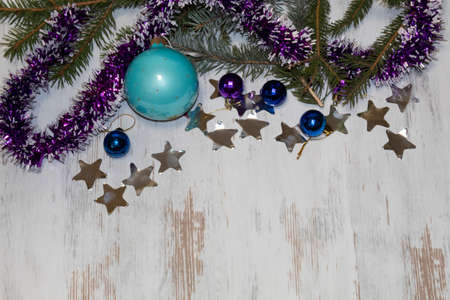 On a light background Christmas composition in blue tones. Spruce branches, tinsel, confetti and blue Christmas balls lie.の写真素材