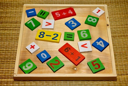 Children's colored wooden set for the study of mathematics. Cheerful learning toys.