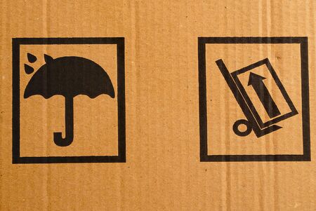 Fragment of a cardboard box with packaging warning signs.の写真素材