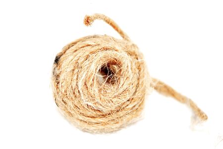 A coil of rough twine, isolated on white.の写真素材