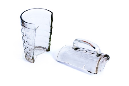 Beer mug broken in two parts on a white background.の写真素材