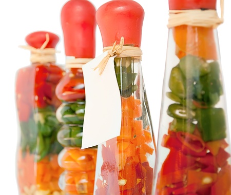 Pickled foods in bottles , decorations in the kitchen, isolated on white. Fragment.の写真素材