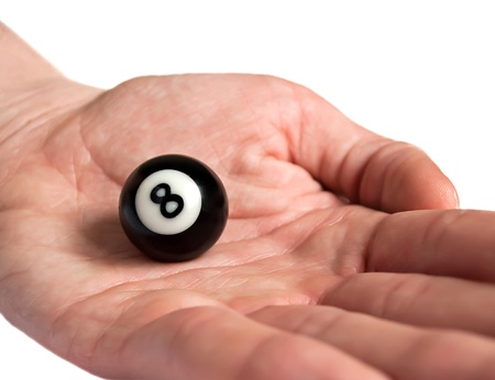 Ball for pool / billiards in hand, black eight. Isolated on white.の写真素材