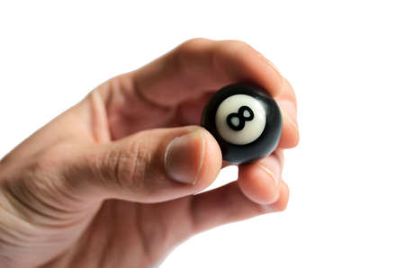 Ball for pool / billiards in hand, black eight. Isolated on white.の写真素材