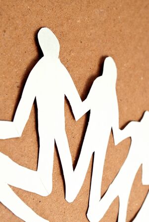 Paper men in unity circle on a cardboard background, fragment.の写真素材