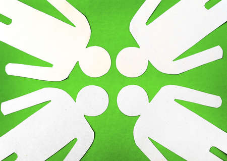 Four paper man on a green backgroundの写真素材