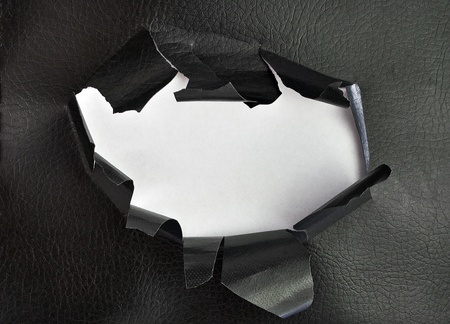 Breakthrough leather hole with white  background.の写真素材