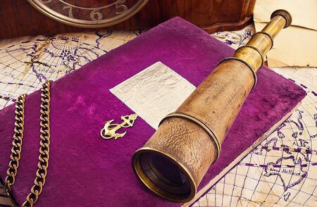 Still life of a navy theme - old spyglass, memory album and some other items.の写真素材