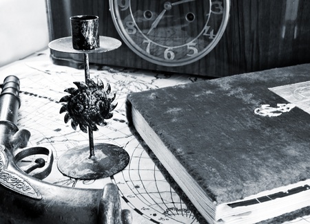 Still life of a navy theme - old candle holder, retro gun and some other items.