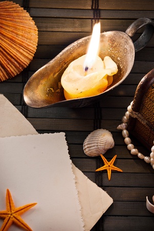 Marine themed background of old sconce with burning candle and some sailor items .の写真素材