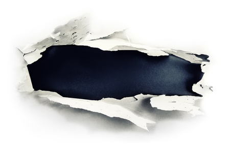 Breakthrough paper hole with dark blue background.の写真素材