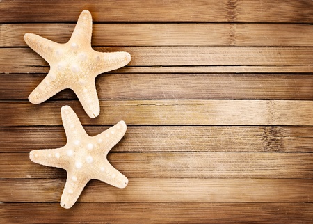 Two seastars on a wooden background.の写真素材