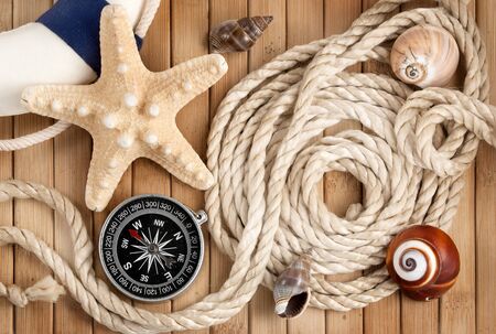 Few summer marine items on a wooden background の写真素材