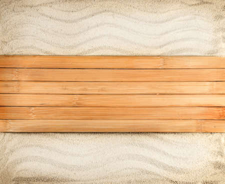 Marine background of wooden planks on a wavy sand の写真素材
