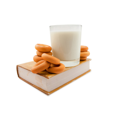 Milk and bagels on book isolated on white.の写真素材
