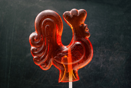 Red candy cock on stick, traditional russian lollipop.の写真素材