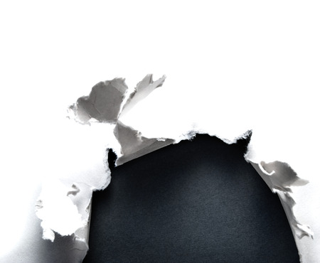 Breakthrough paper hole with gray background.の写真素材