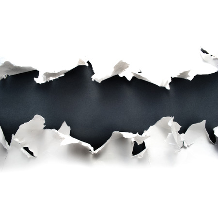 Torn paper hole with gray background.の写真素材