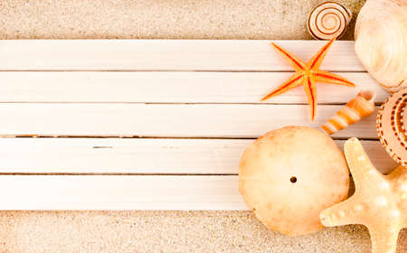 Few marine items on a wooden planks over sandy background.の写真素材