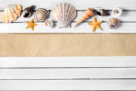 Few marine items on a wooden planks over sandy background.の写真素材