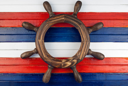Miniature steering wheel on a wooden background.の写真素材