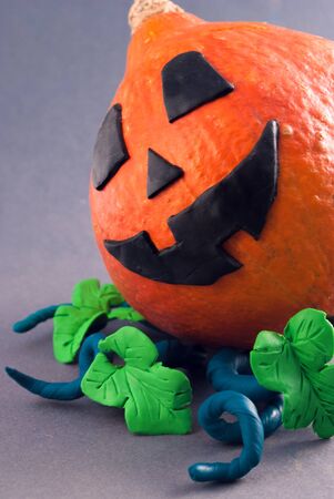 Halloween pumpkin with plasticine details.の写真素材