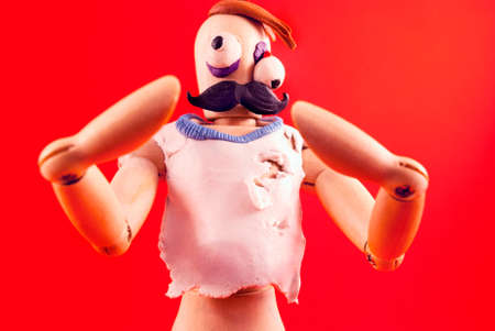 Classic wooden dummy infected by plasticine becomes zombie.の写真素材