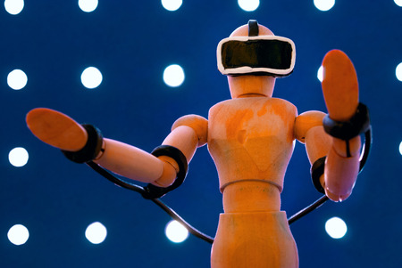Classic wooden dummy uses a plasticine virtual reality headset.の写真素材