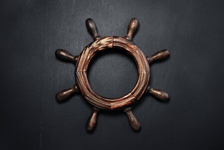 Wooden steering wheel on a chalkboard.の写真素材