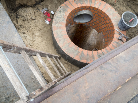 View of a trench with an unfinished sewage shaft.の写真素材