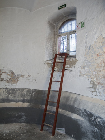 Emergency exit with ladder in the basement of a ruin.の写真素材
