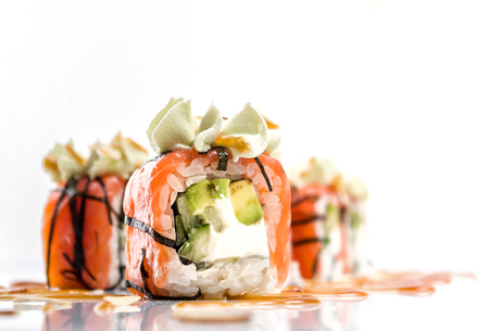 Sushi with salmon, cucumber and seaweeds isolated on whiteの写真素材