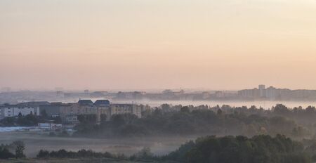 Morning mist over the city at sunriseの写真素材